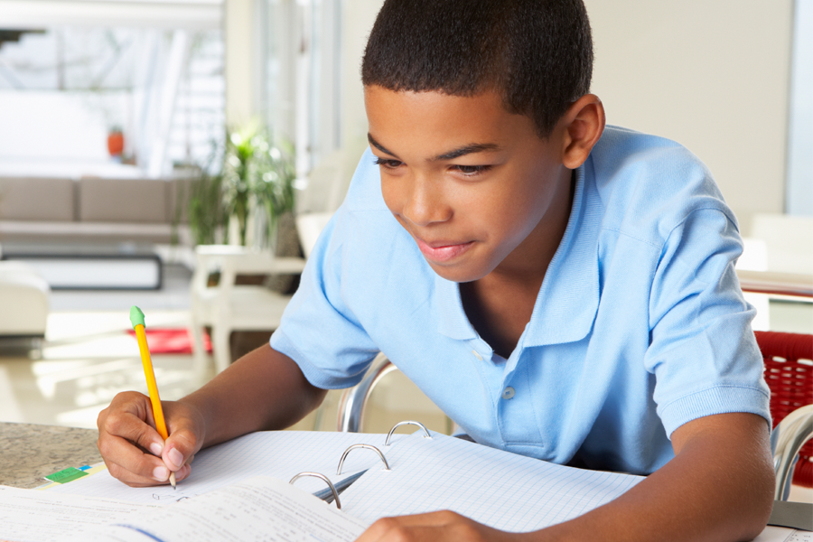 I do my homework today. Boy doing homework. Boy writing. Boy in his Room doing homework. Child writing homework.